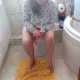 A plump girl is recorded from a between the legs perspective as she takes a firm shit and a piss while sitting on a toilet. Presented in 720P HD. Over a minute.